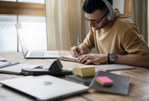 young-man-writing-notebook-study-session